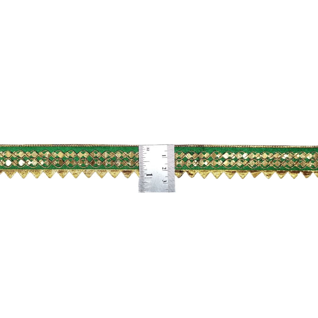 Decorative green and gold border with a ruler for scale on a white background